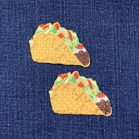 Two taco-shaped patches on a denim background