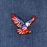 Embroidered eagle patch with American flag design on denim fabric