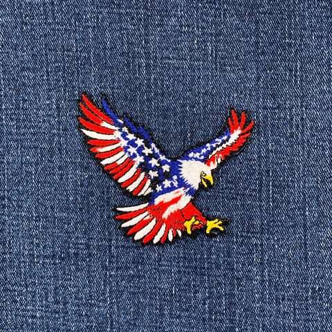 Embroidered eagle patch with American flag design on denim fabric