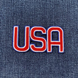 Embroidered 'USA' patch on denim fabric