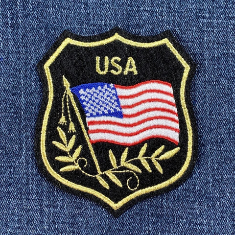 Embroidered patch with American flag and 'USA' text on denim fabric