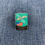 Pin with uss arizona memorial design and American flag on a denim background
