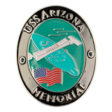 An oval medallion reading 'USS ARIZONA MEMORIAL' with a turquoise center, silver-toned border, a white airplane, and a small American flag at the bottom, shown on a plain white background.