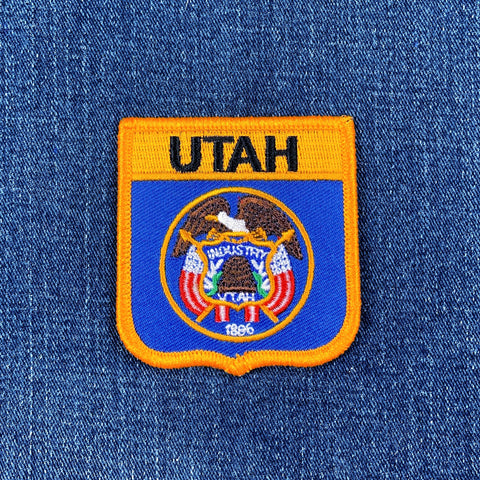 Utah state emblem patch on a denim background