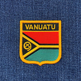 Vanuatu flag patch on a blue fabric background