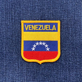 Venezuelan flag patch on a blue denim background