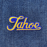Embroidered patch with 'Tahoe' text on denim fabric