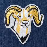 Embroidered patch of a ram's head on denim fabric