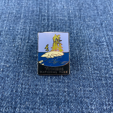 Pin with Voyageurs National Park design on a denim background