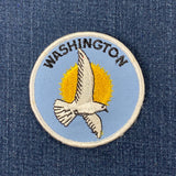 Embroidered patch with a dove and 'Washington' text on a blue background
