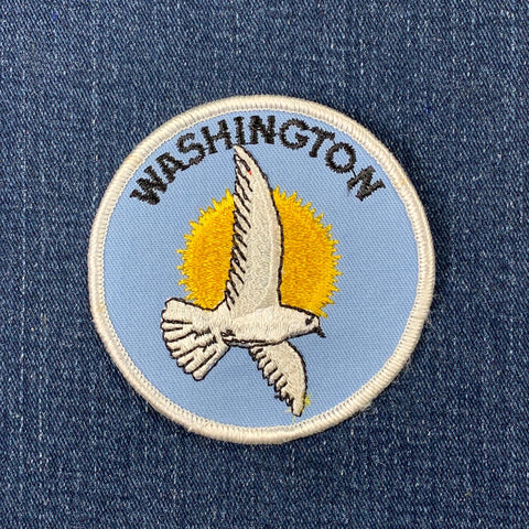 Embroidered patch with a dove and 'Washington' text on a blue background