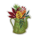 Embroidered patch of a green watering can with colorful flowers on a white background