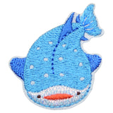 Blue whale-shaped patch with white polka dots on a white background