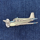 Embroidered airplane patch on denim fabric