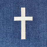 White cross patch on blue denim fabric