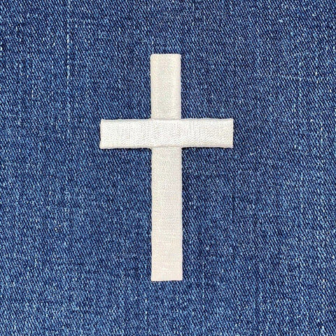 White cross patch on blue denim fabric