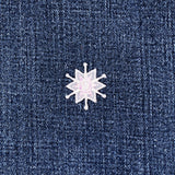 White snowflake patch on a denim background