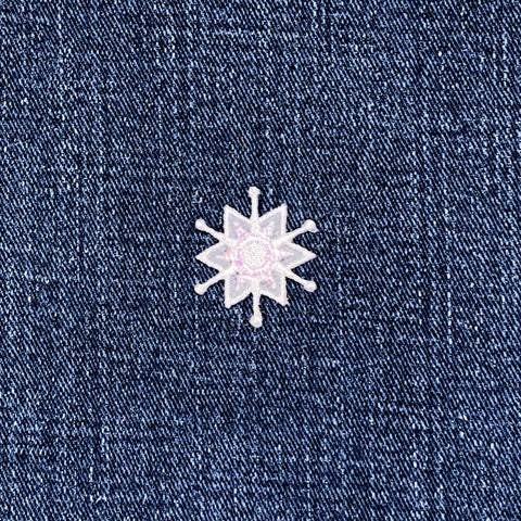 White snowflake patch on a denim background