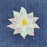 Iridescent flower patch on denim fabric