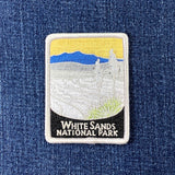 Embroidered patch of White Sands National Park on a denim background