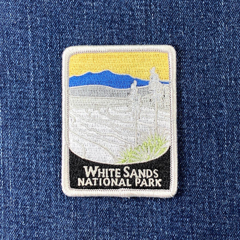 Embroidered patch of White Sands National Park on a denim background