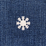 White snowflake patch on a blue denim background