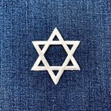 white Star of David patch on blue denim fabric
