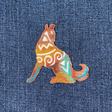 southwest wolf embroidered patch on a denim background