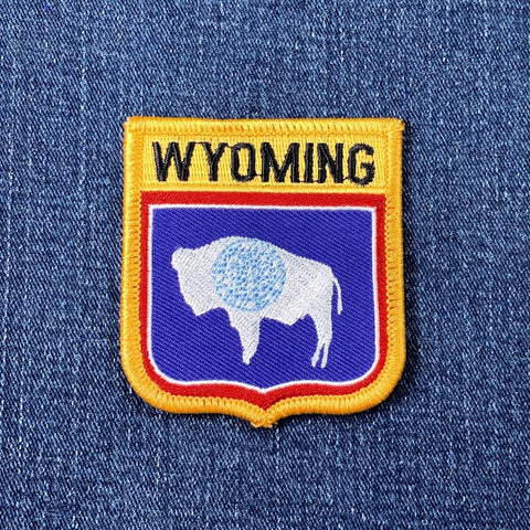 Wyoming patch with a buffalo design on a denim background