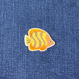 Fish-shaped patch on denim fabric