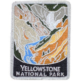 An embroidered rectangular patch for Yellowstone National Park, featuring a stylized landscape with gray mountains, orange and yellow canyon walls, a blue river, and a black bottom section with white text reading 'YELLOWSTONE NATIONAL PARK'.