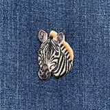 Embroidered zebra patch on denim fabric