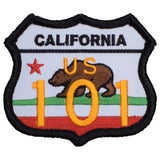 A patch with a shield shape featuring the text 'CALIFORNIA US 101' and an image of a California grizzly bear.