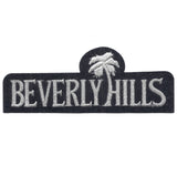 A black patch with the text 'BEVERLY HILLS' and a palm tree embroidered in white.