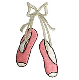 A pair of pink ballet slippers with silver accents, tied with a ribbon, designed as an iron-on applique patch.