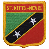 A shield-shaped embroidered patch with the text 'ST. KITTS-NEVIS' on it, featuring a green, red, and black color scheme with white stars.