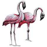 A pair of pink flamingos applique patches with a shimmery texture, designed for iron-on application.