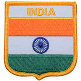A shield-shaped embroidered patch with vertical stripes in orange, white, and green colors, and the Indian flag's Ashoka Chakra in the center. Text says 'INDIA' at the top.