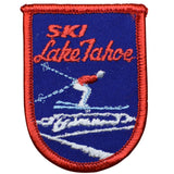 A vintage patch with a blue background and red trim featuring the text 'Ski Lake Tahoe' and an image of a snow ski.