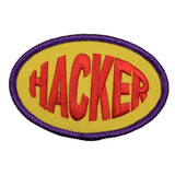 A round embroidered patch with the word 'HACKER' written in bold letters, outlined with a yellow border and a purple background.