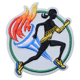 A patch featuring a running track and field motif with a silhouette of a marathon runner, a torch, and a track.