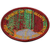 An oval-shaped patch featuring text and an image of redwood trees along a road.
