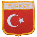 An embroidered patch featuring the flag of Turkey with a crescent and star on a red background, bordered in yellow, with the word 'TURKEY' across the top.