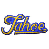 A vintage embroidered patch with the word Tahoe written in a cursive script, featuring blue and yellow colors, designed to be ironed onto fabric.