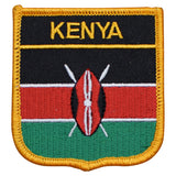 A shield-shaped embroidered patch with vertical stripes in black, red, and green, featuring the word 'KENYA' and a national emblem.