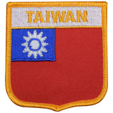 A shield-shaped embroidered patch with the text 'TAIWAN' on the top, featuring the flag of Taiwan, which includes a sun on a blue square on the left and a red field on the right separated by a yellow border.