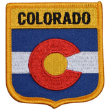 A shield-shaped embroidered patch with the state flag of Colorado, featuring a red and blue background with a white diagonal stripe and a yellow 'C' in the center.