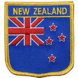 A shield-shaped embroidered patch with a blue background, featuring the flag of New Zealand and the text 'NEW ZEALAND' at the top.