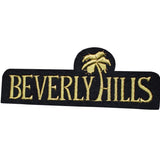 A black patch with the words 'BEVERLY HILLS' written in gold letters, topped with a stylized palm tree also in gold.