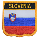 A shield-shaped embroidered patch with the flag colors and emblem of Slovenia, labeled 'SLOVENIA'